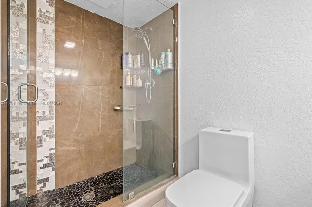 a white toilet sitting next to a bathroom