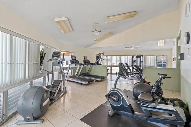 a living room with furniture a dining table and a chandelier