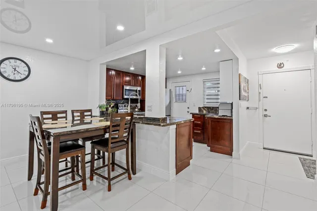 a kitchen with a refrigerator and a stove top oven