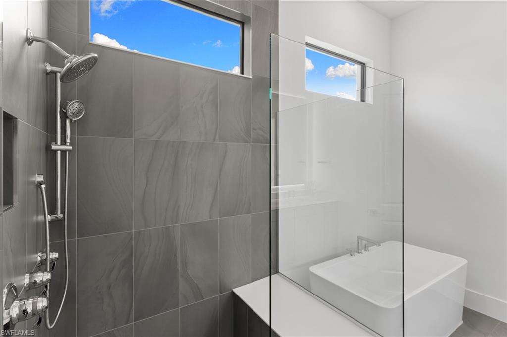 19084 Gentry Place Estero, FL 33928 - Photo 25 of 44 Abundant natural light with above-transom windows, separate soaking tub, and walk-in shower