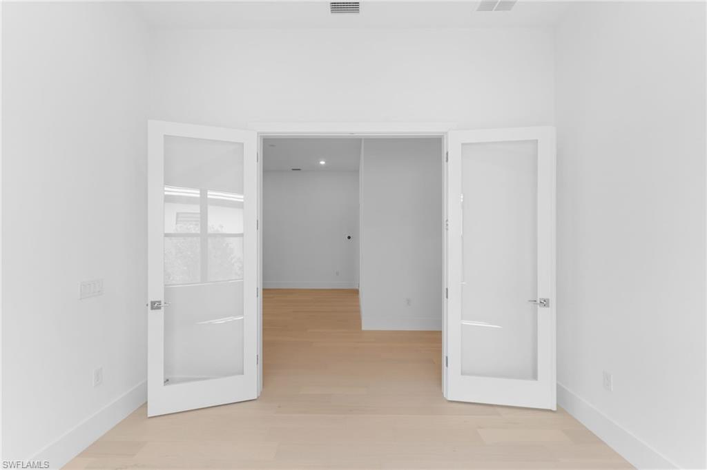 19084 Gentry Place Estero, FL 33928 - Photo 30 of 44 Private den or flex room with glass doors and windows, ideal for a home office