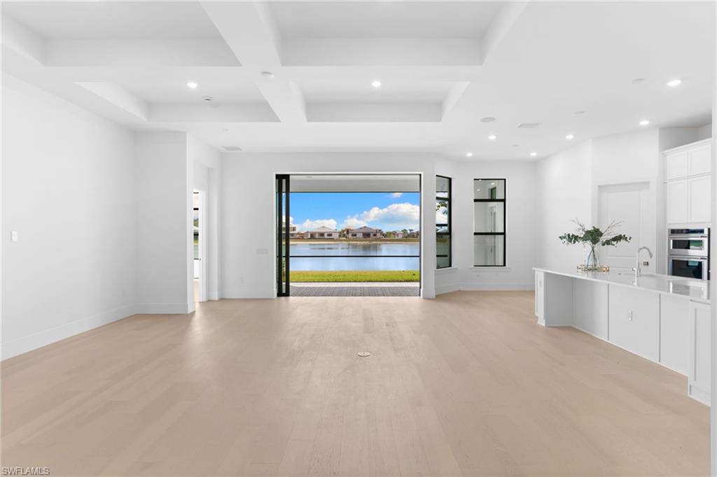 19084 Gentry Place Estero, FL 33928 - Photo 4 of 44 Open living, dining, and kitchen with serene pond views