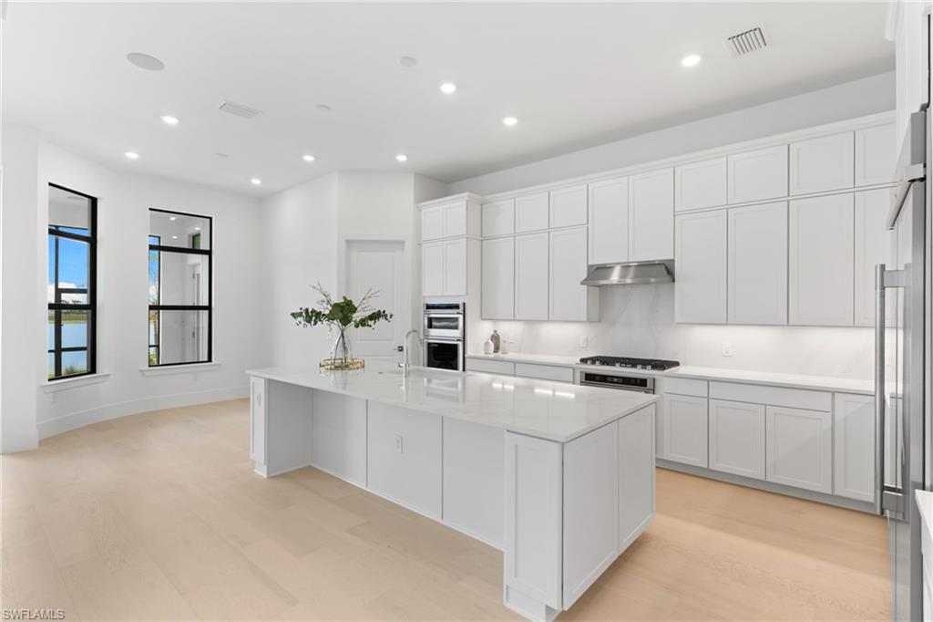 19084 Gentry Place Estero, FL 33928 - Photo 8 of 44 Gourmet island with 3CM Calacatta Silestone countertops and backsplash