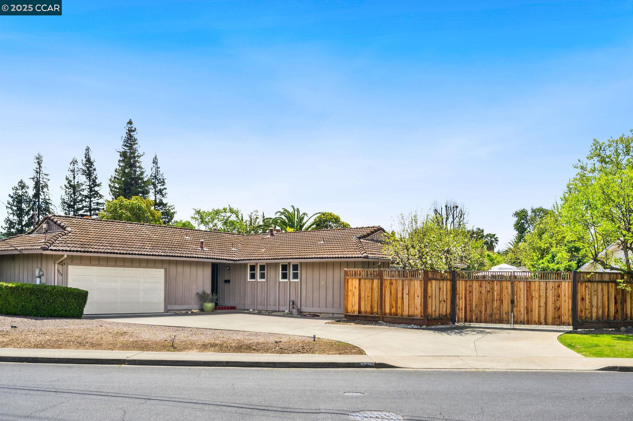a view of a house with a wooden fence