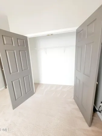 a view of a room with wooden floor and door