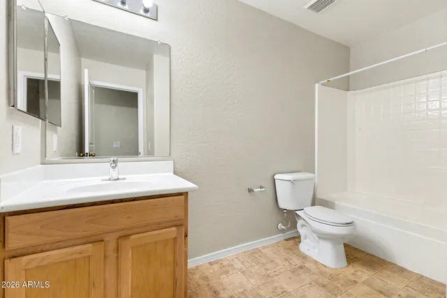 a bathroom with a granite countertop sink toilet and a mirror