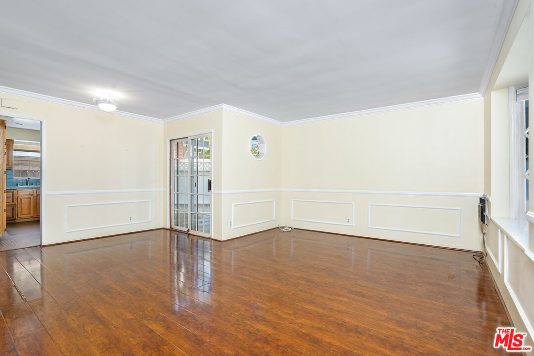 12334 Moorpark Street Studio City, CA 91604 - Photo 17 of 33 an empty room with wooden floor door and windows