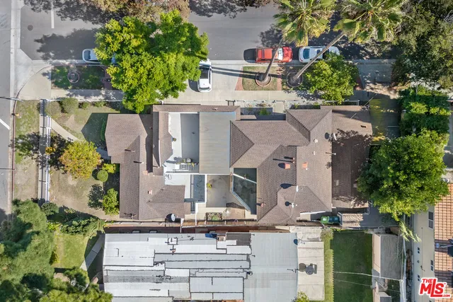 an aerial view of multiple houses with outdoor space