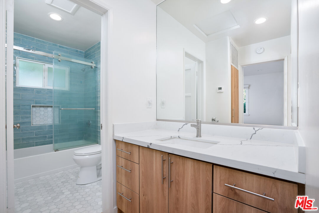 12334 Moorpark Street Studio City, CA 91604 - Photo 24 of 33 a bathroom with a sink and a mirror