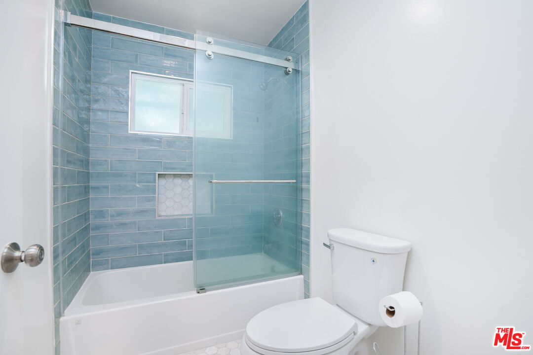 12334 Moorpark Street Studio City, CA 91604 - Photo 25 of 33 a white toilet sitting next to a bath tub