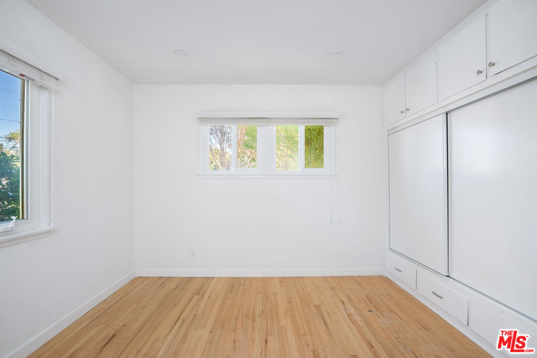 12334 Moorpark Street Studio City, CA 91604 - Photo 26 of 33 a view of an empty room with wooden floor and a window