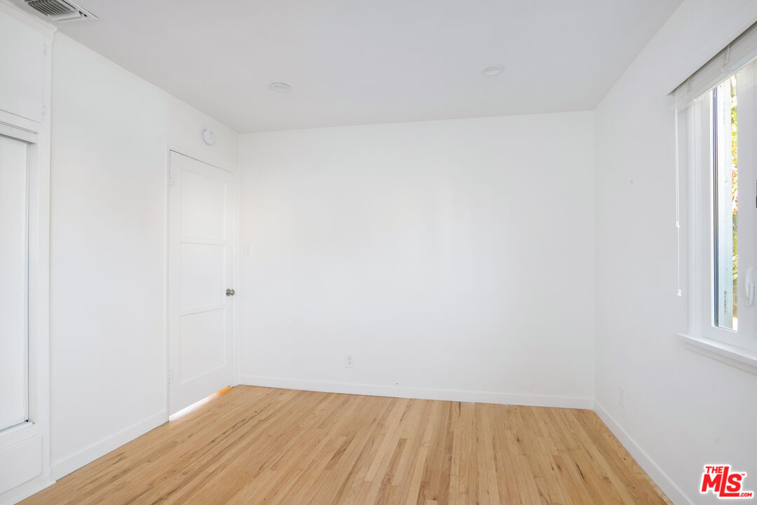 12334 Moorpark Street Studio City, CA 91604 - Photo 27 of 33 a view of small space with wooden floor and windows