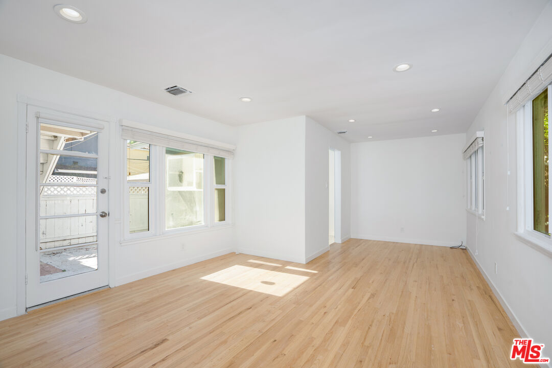 12334 Moorpark Street Studio City, CA 91604 - Photo 28 of 33 a view of empty room with wooden floor and fan