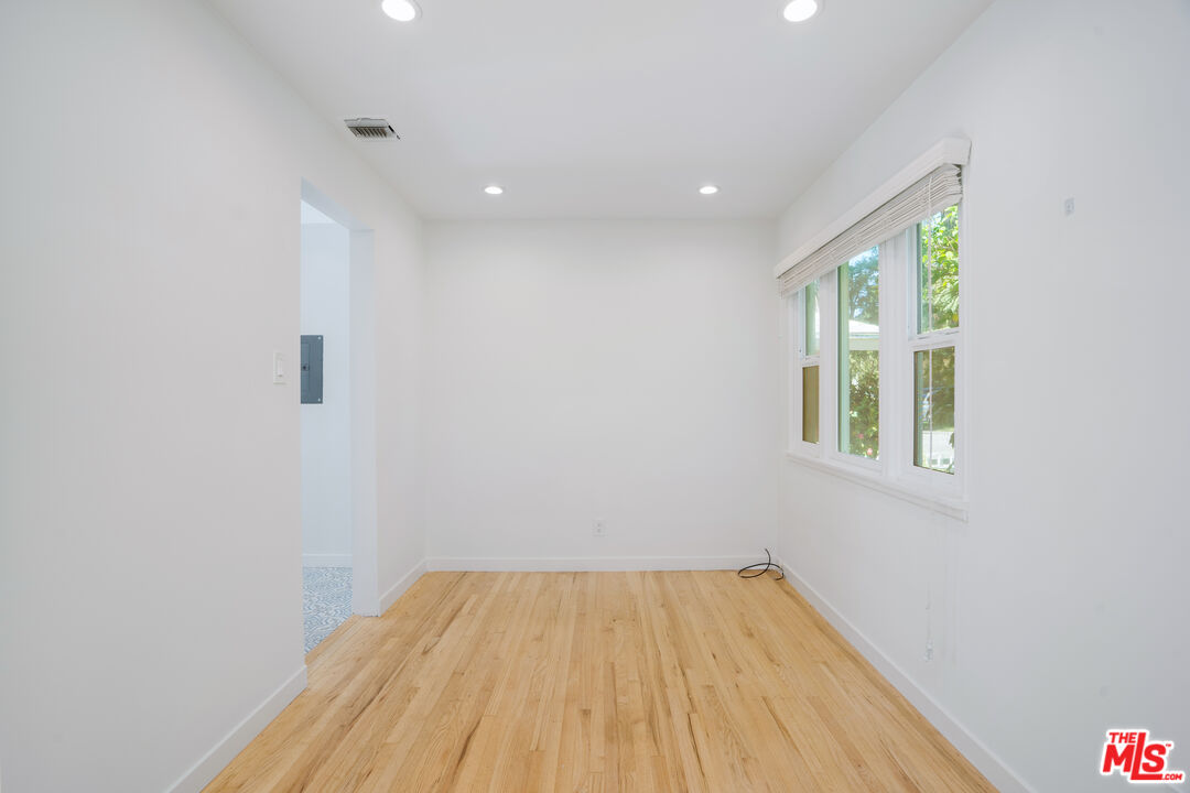 12334 Moorpark Street Studio City, CA 91604 - Photo 29 of 33 a view of empty room with wooden floor and fan
