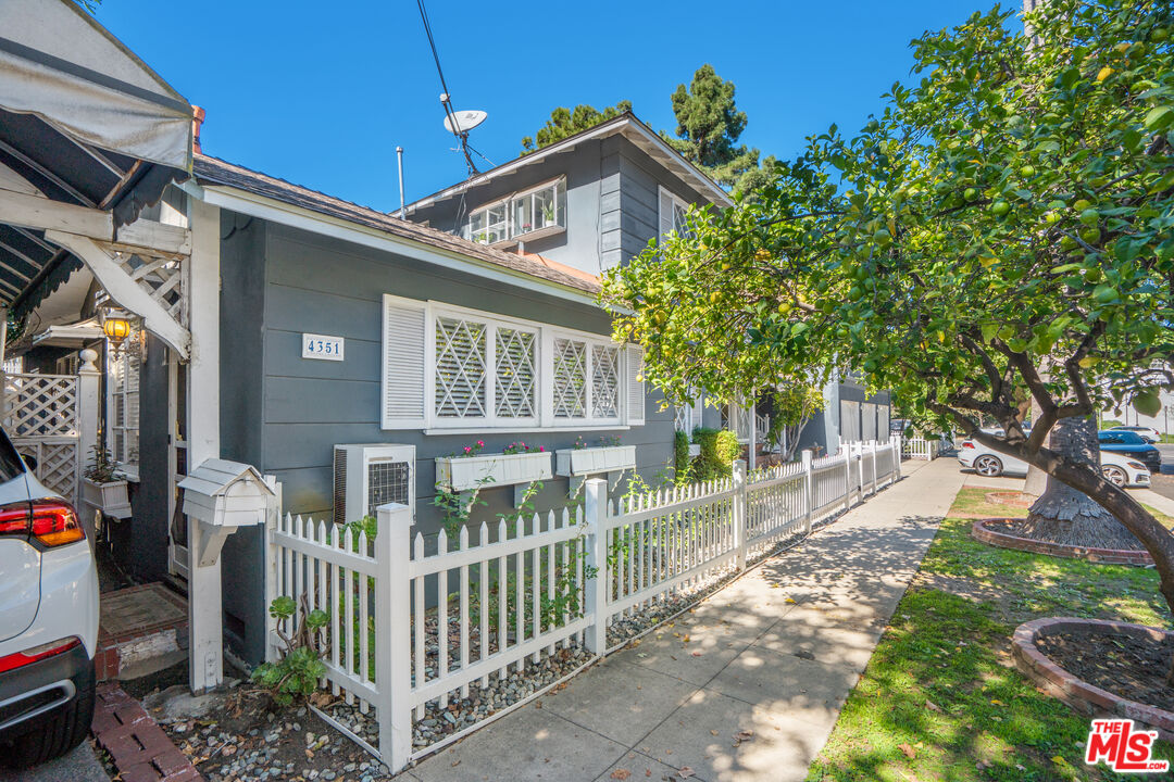 12334 Moorpark Street Studio City, CA 91604 - Photo 9 of 33 a front view of a house with a yard