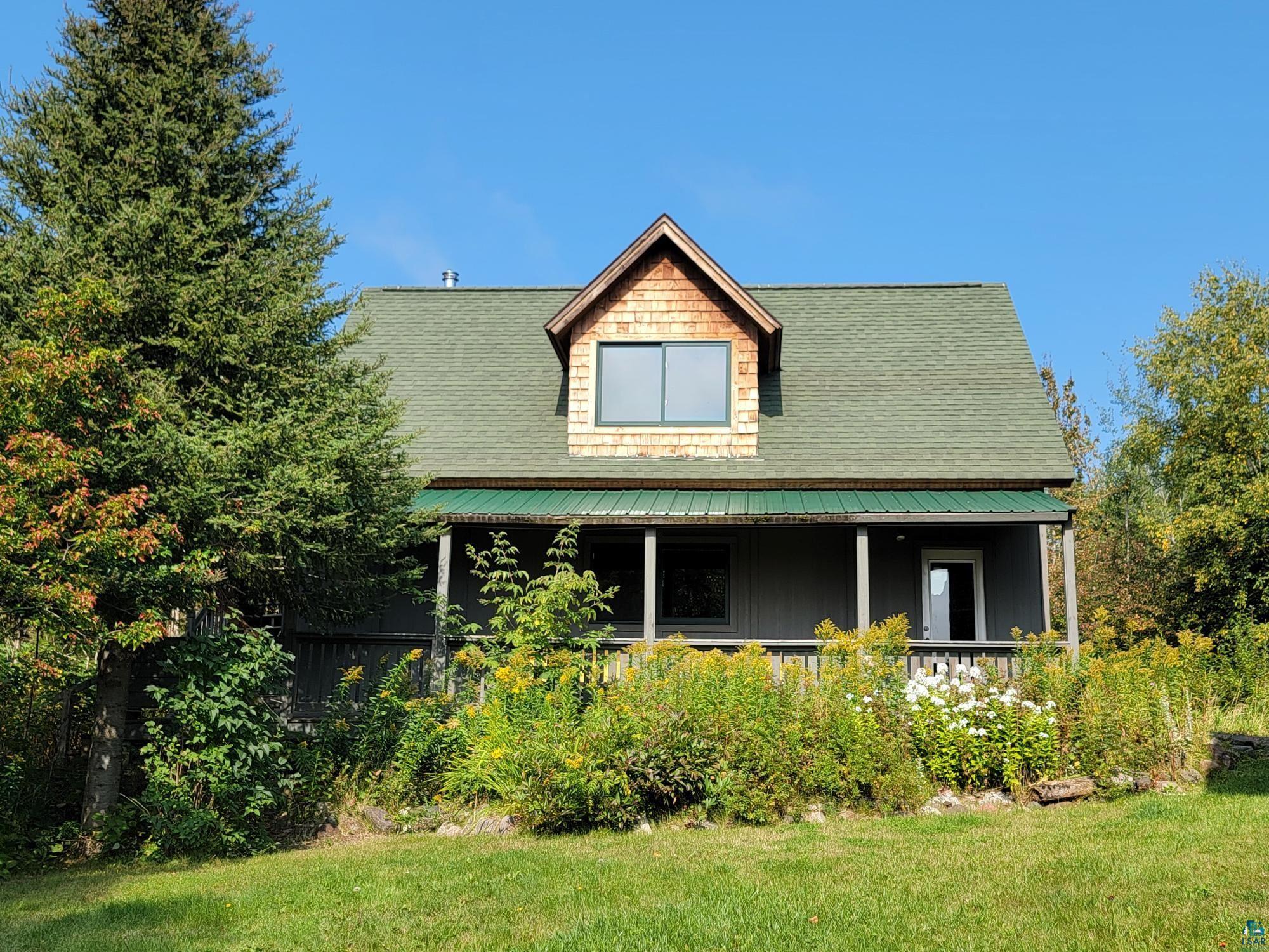 184 Fall River Road Grand Marais, MN 55604 - Photo 11 of 50 Back of property with a yard and a porch