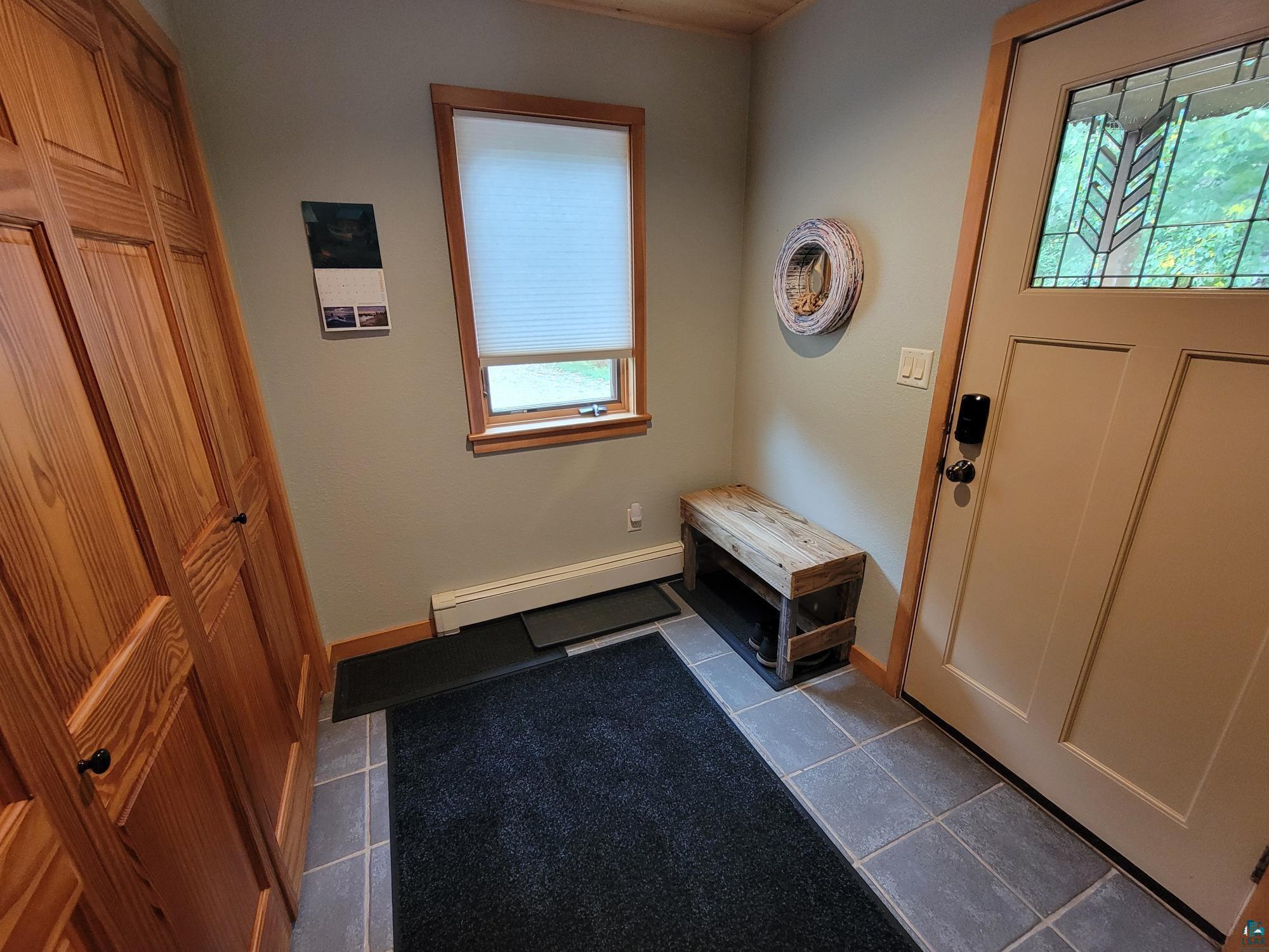 184 Fall River Road Grand Marais, MN 55604 - Photo 14 of 50 Tiled entrance foyer with a baseboard radiator
