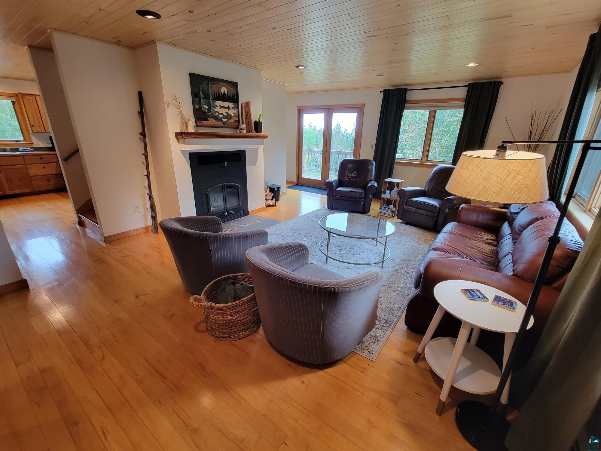 184 Fall River Road Grand Marais, MN 55604 - Photo 17 of 50 Living room featuring light wood-type flooring and wooden ceiling
