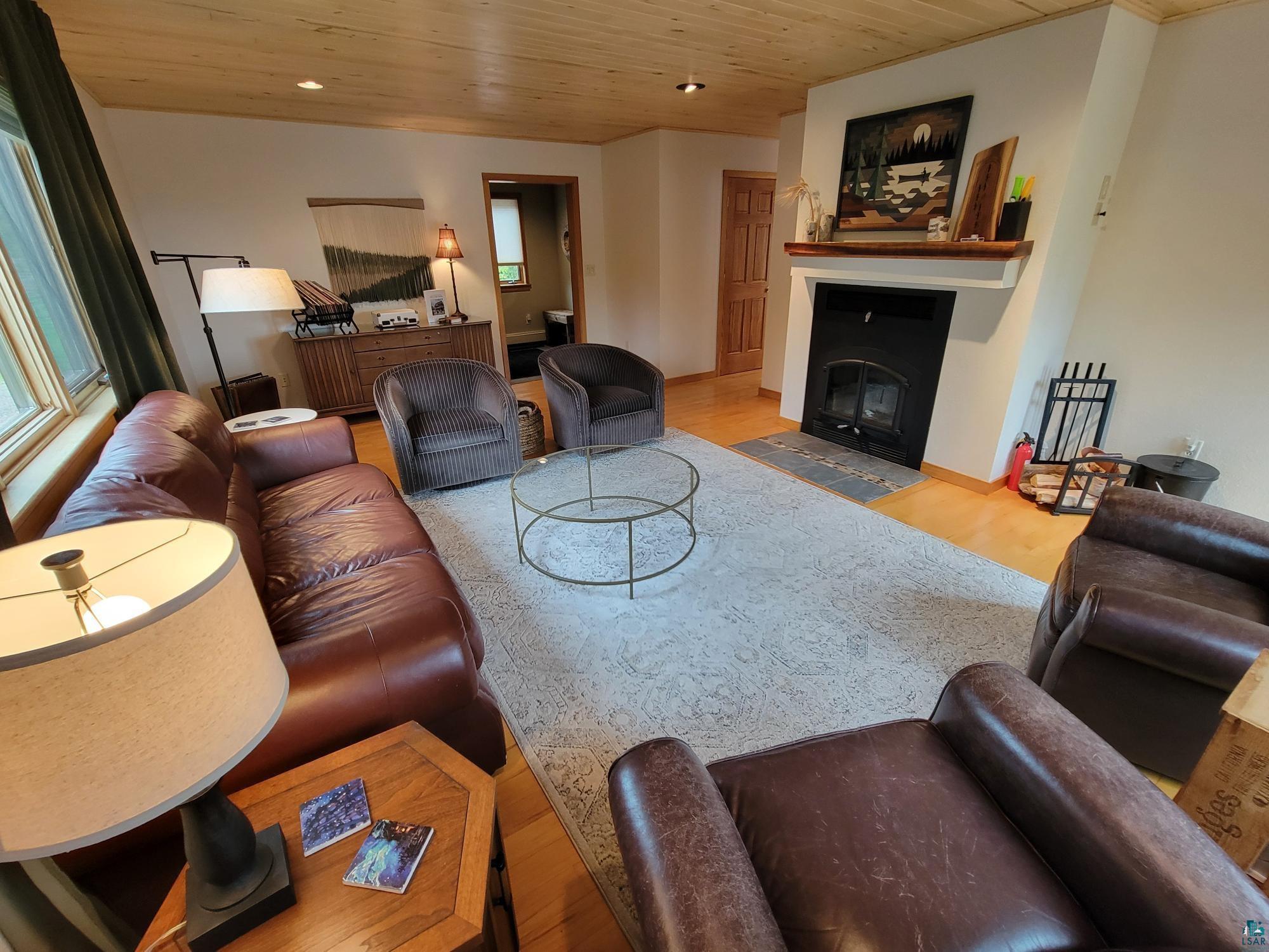 184 Fall River Road Grand Marais, MN 55604 - Photo 19 of 50 Living room featuring light wood-type flooring and wooden ceiling