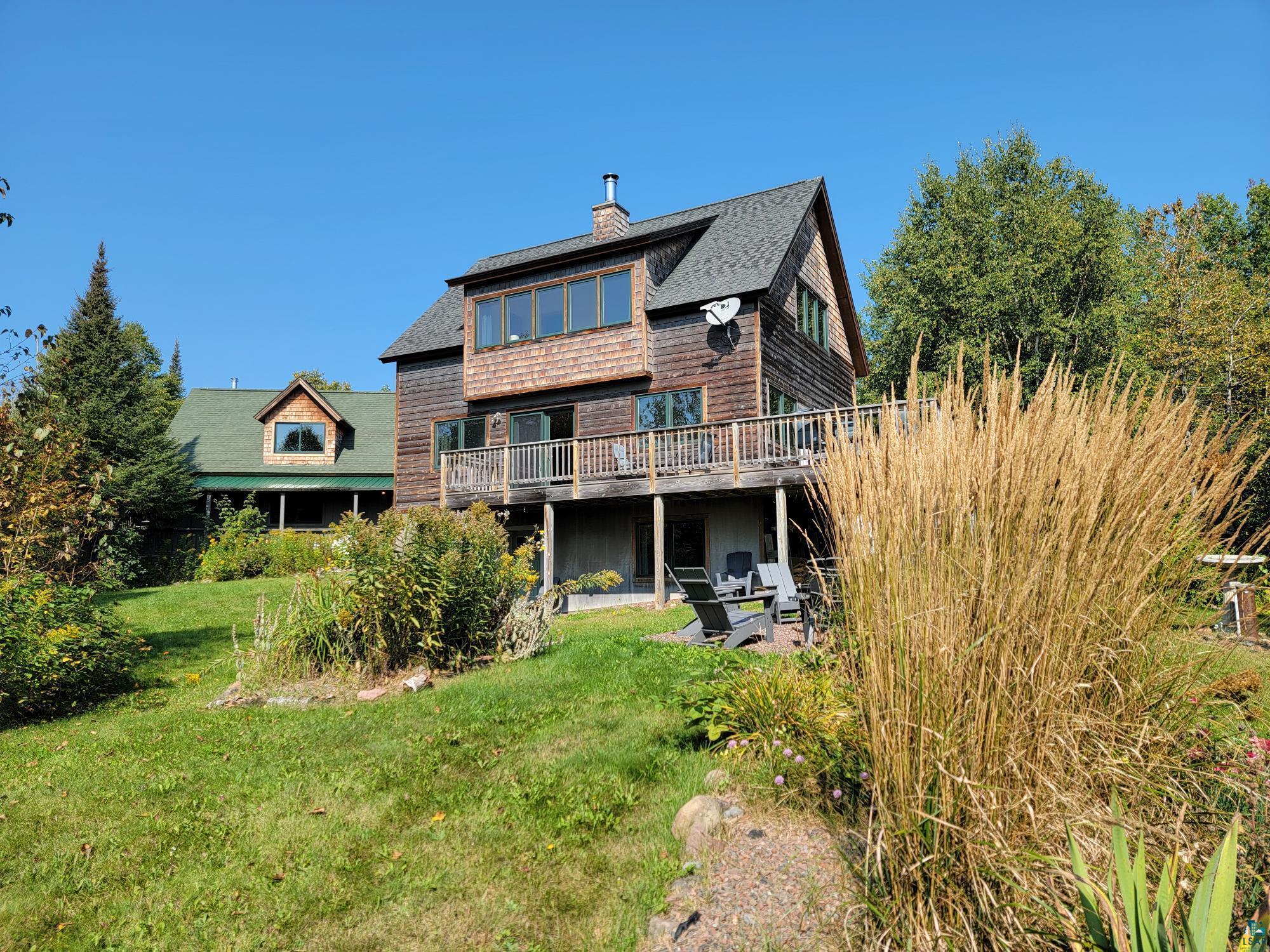 184 Fall River Road Grand Marais, MN 55604 - Photo 2 of 50 Back of house featuring a yard and a deck