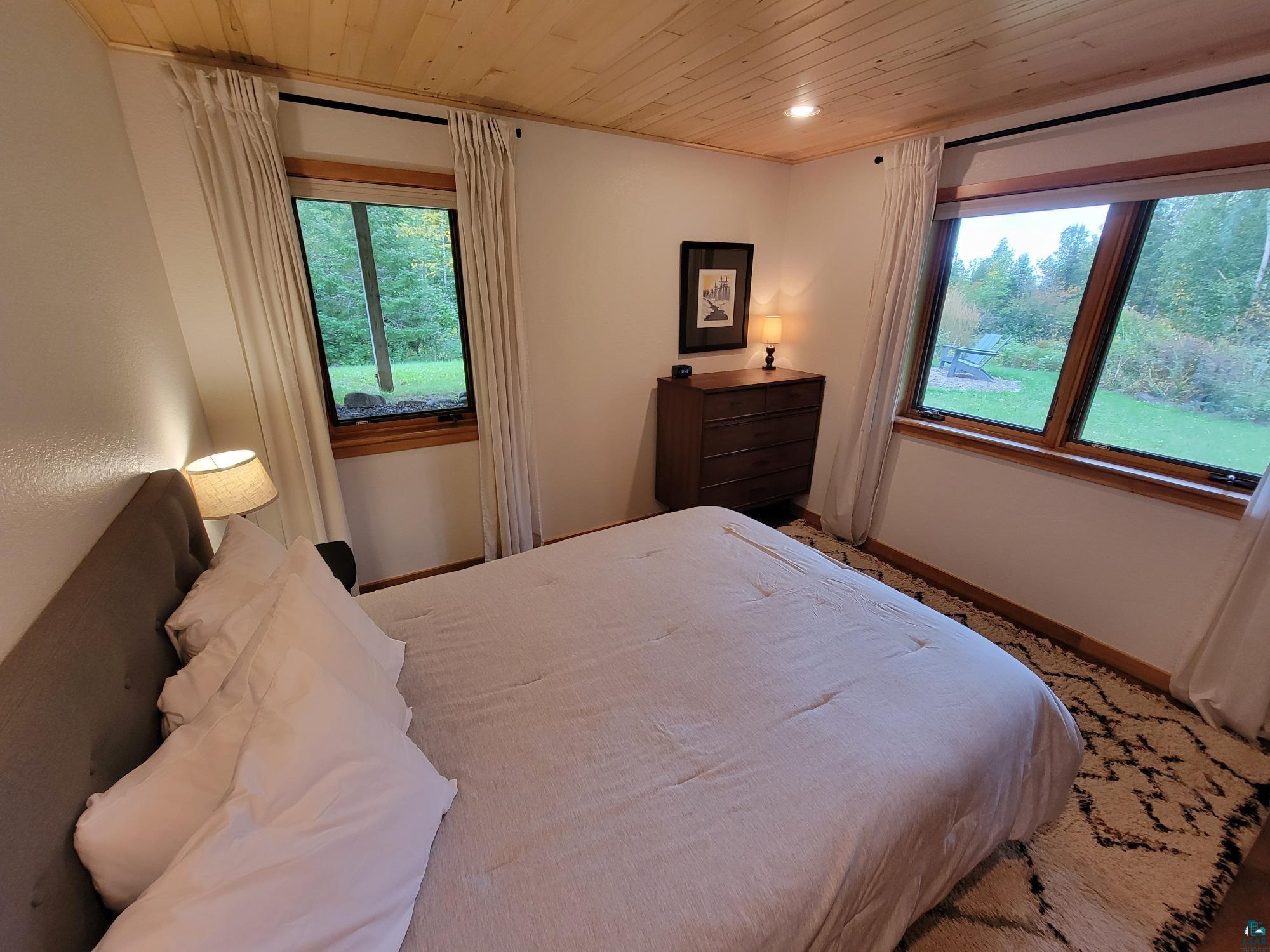 184 Fall River Road Grand Marais, MN 55604 - Photo 40 of 50 Bedroom with wooden ceiling and multiple windows