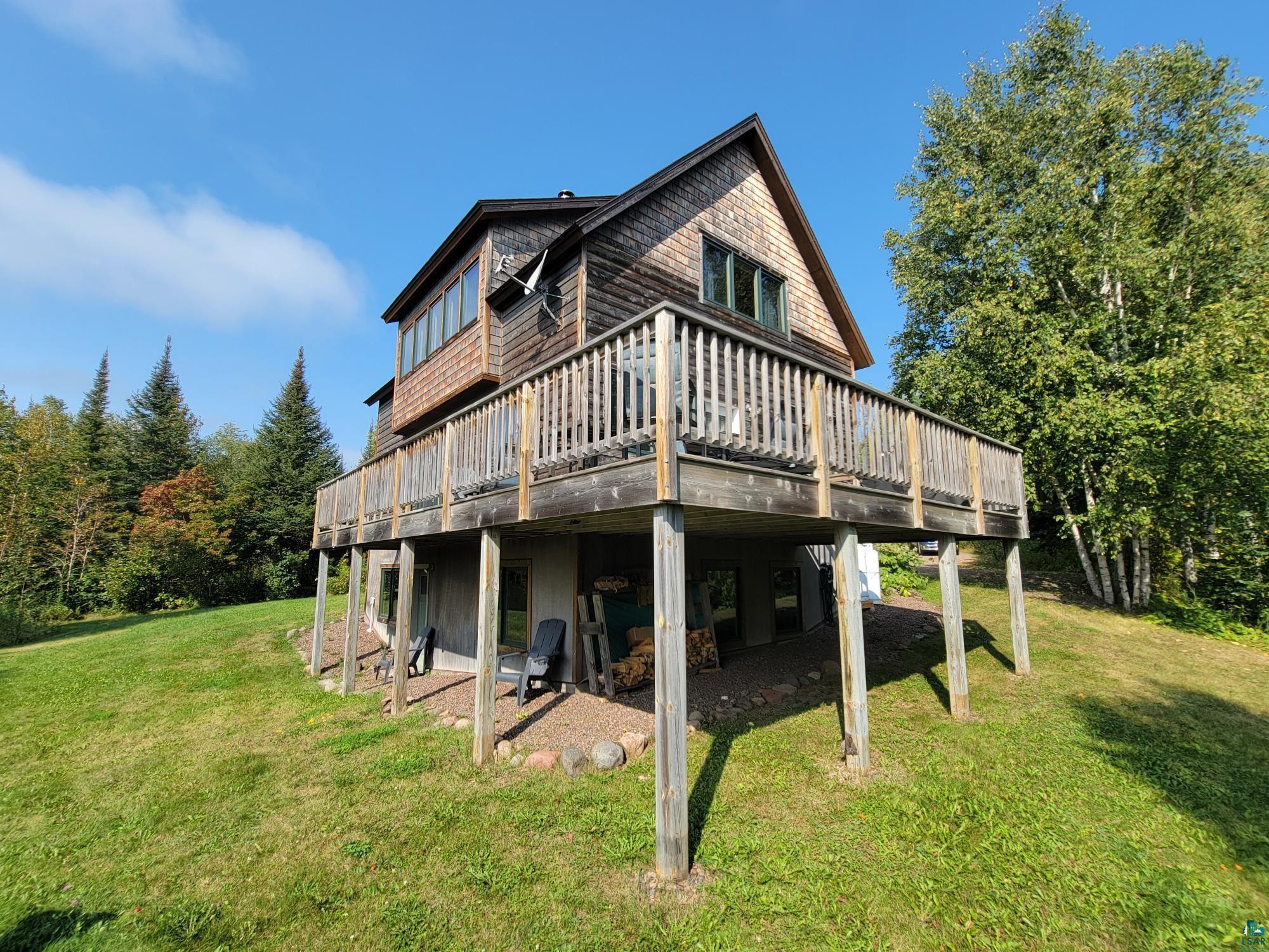 184 Fall River Road Grand Marais, MN 55604 - Photo 4 of 50 Rear view of property with a patio area, a lawn, and a wooden deck