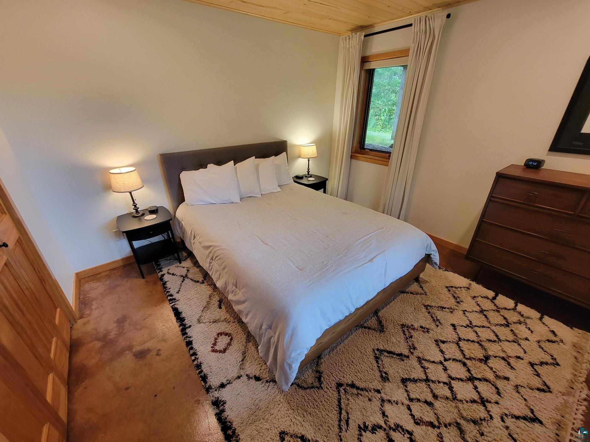 184 Fall River Road Grand Marais, MN 55604 - Photo 41 of 50 Carpeted bedroom featuring wooden ceiling