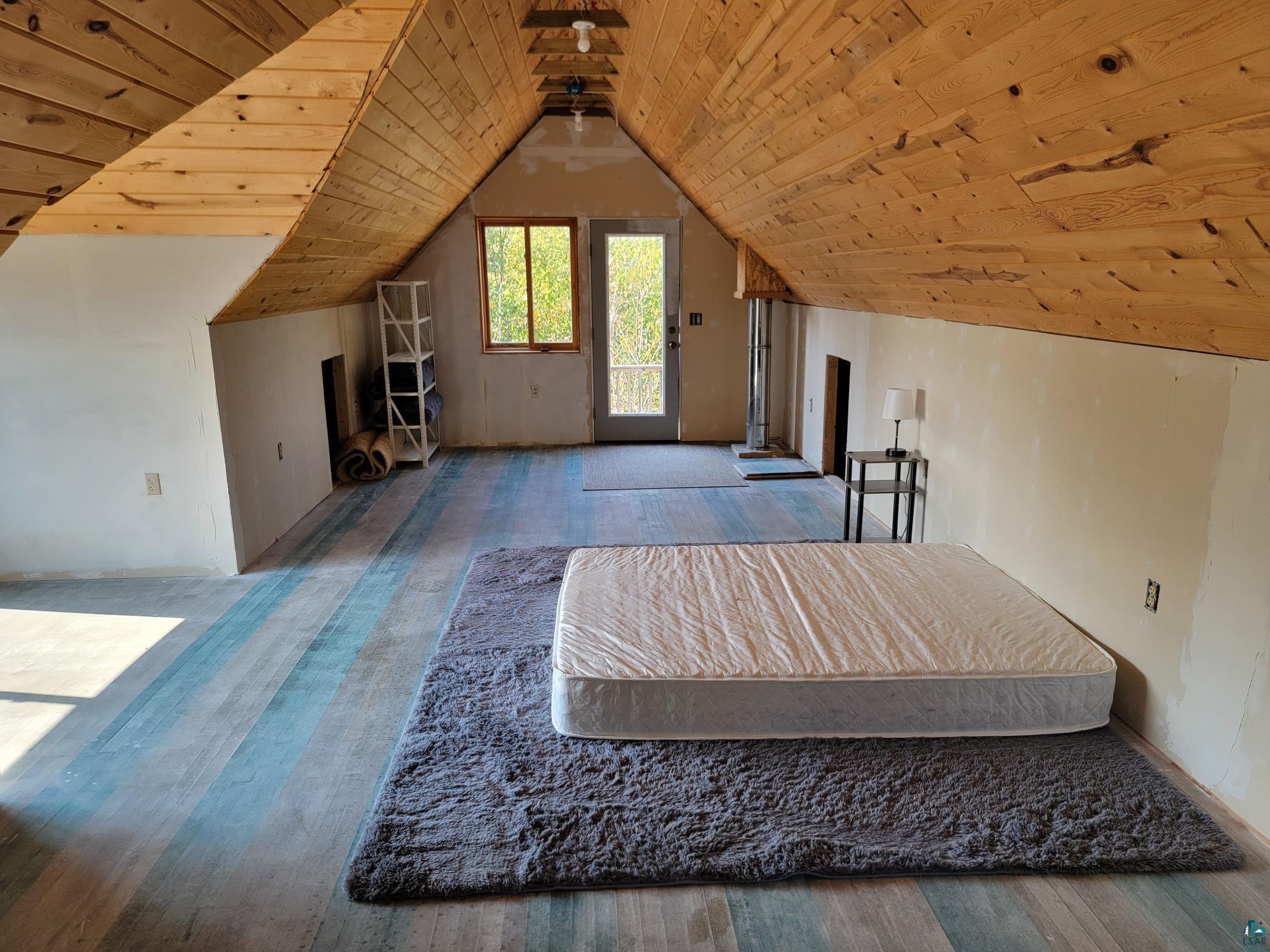 184 Fall River Road Grand Marais, MN 55604 - Photo 48 of 50 Additional living space featuring wood-type flooring, wood ceiling, and vaulted ceiling