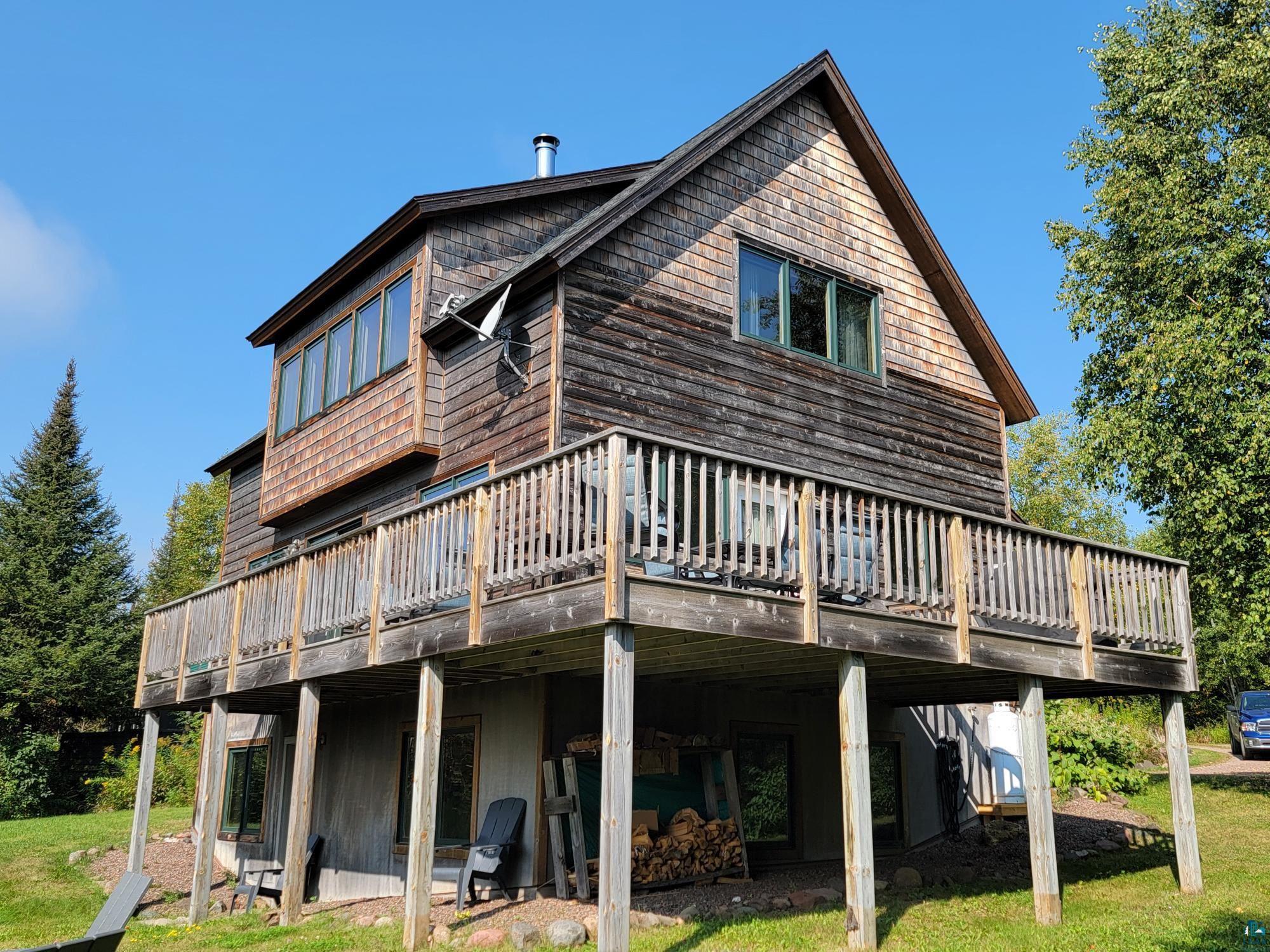 184 Fall River Road Grand Marais, MN 55604 - Photo 5 of 50 Back of property with a wooden deck and a lawn