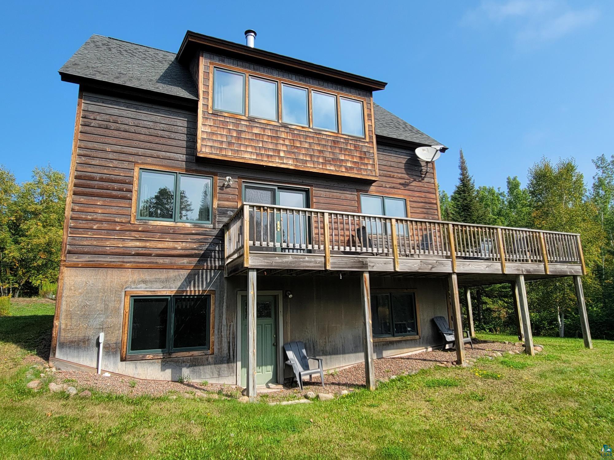 184 Fall River Road Grand Marais, MN 55604 - Photo 6 of 50 Back of property featuring a yard and a wooden deck