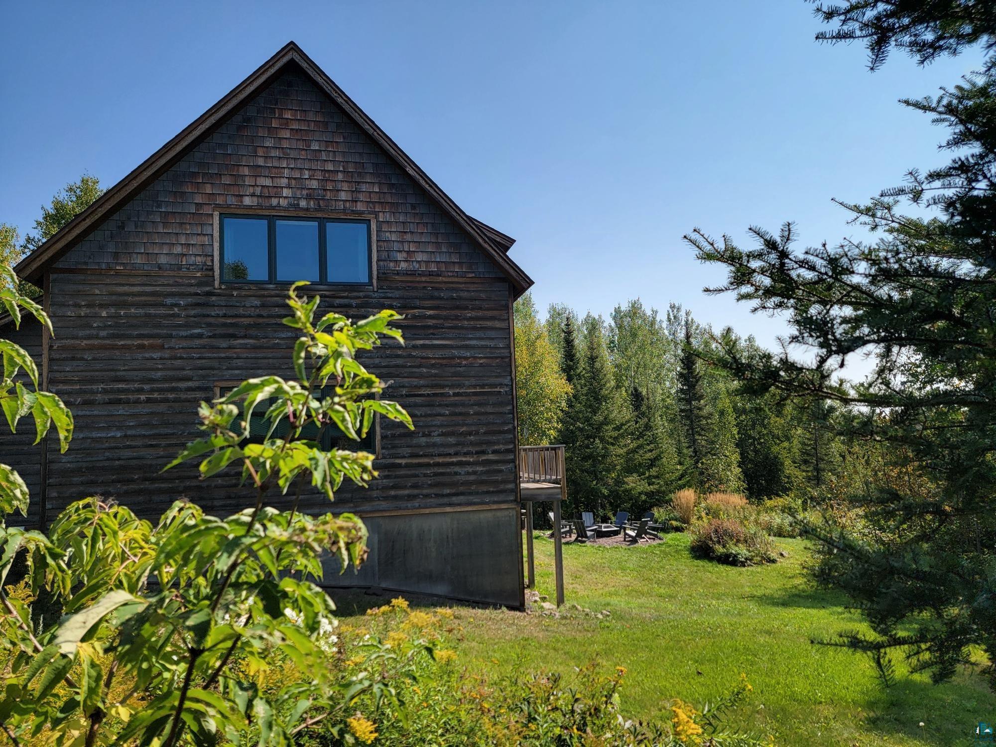 184 Fall River Road Grand Marais, MN 55604 - Photo 7 of 50 View of side of property featuring a yard