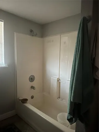 a bathroom with a bathtub and a shower