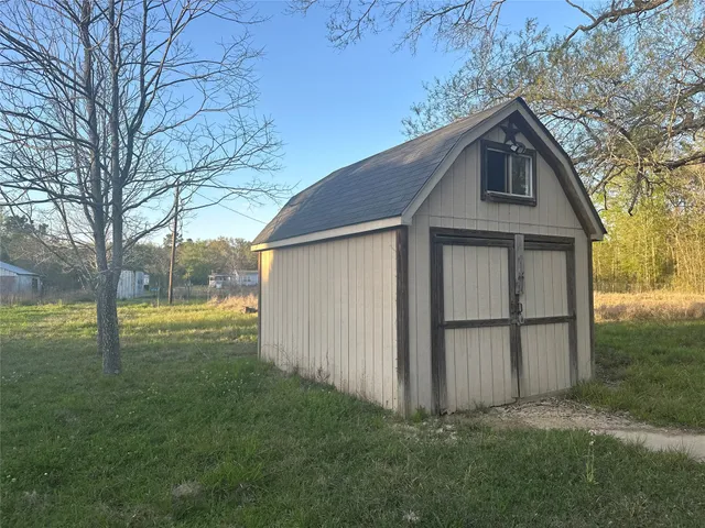 a view of a backyard with large trees