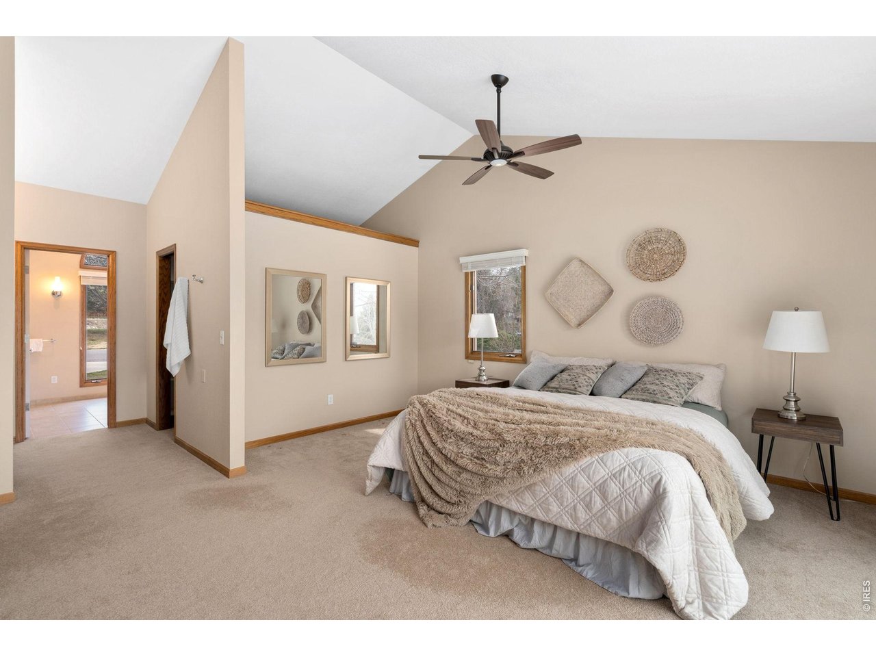 1819 Linden Lake Road Fort Collins, CO 80524 - Photo 22 of 49 a bedroom with a large bed and a chandelier