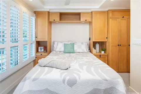 a bedroom with a large bed and a window