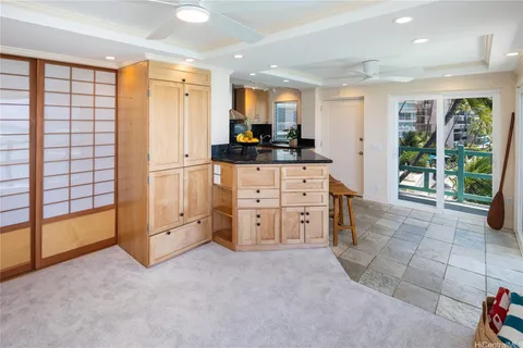 a bedroom with a bed and a refrigerator