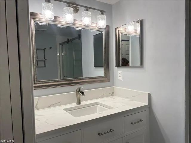 a bathroom with a sink and a mirror