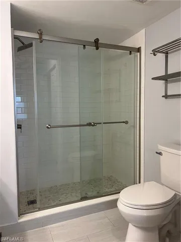 a bathroom with a shower and a toilet