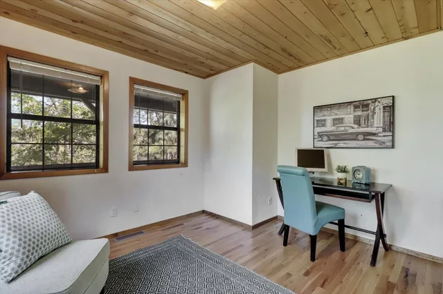 wooden floor in an empty room with a window