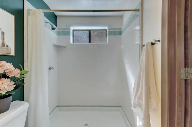 a view of an empty room with wooden floor and closet