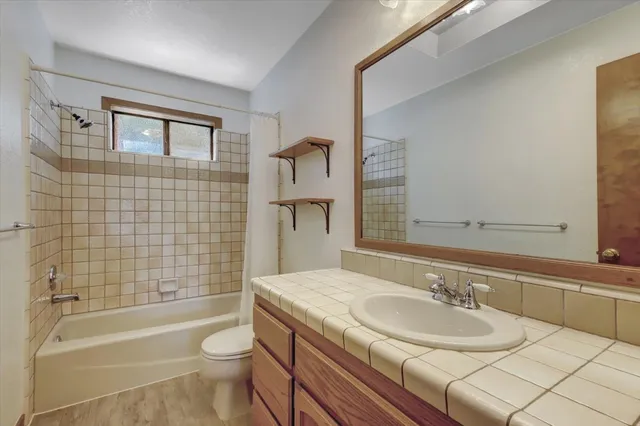 a view of a wooden house with large trees
