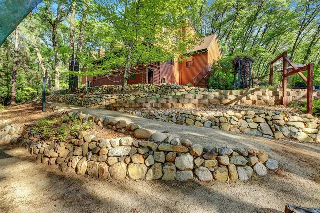 a view of a yard with large trees