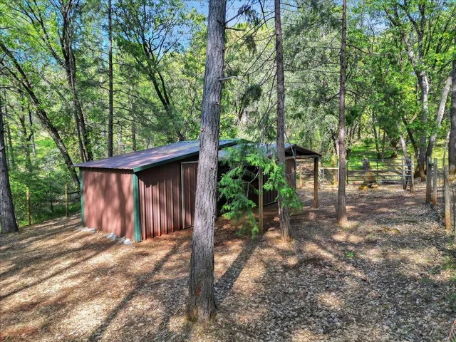 a view of a patio with chair and tables back yard of the house