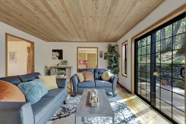 a kitchen with stainless steel appliances granite countertop a stove a sink dishwasher and cabinets with wooden floor