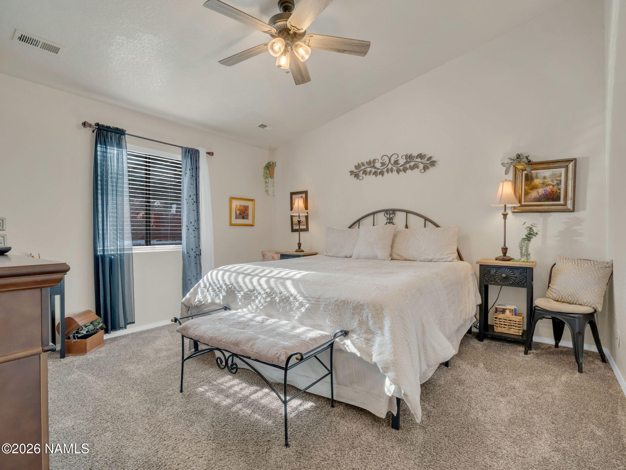1105 West Morse Avenue Williams, AZ 86046 - Photo 13 of 26 a bedroom with a bed and a chandelier