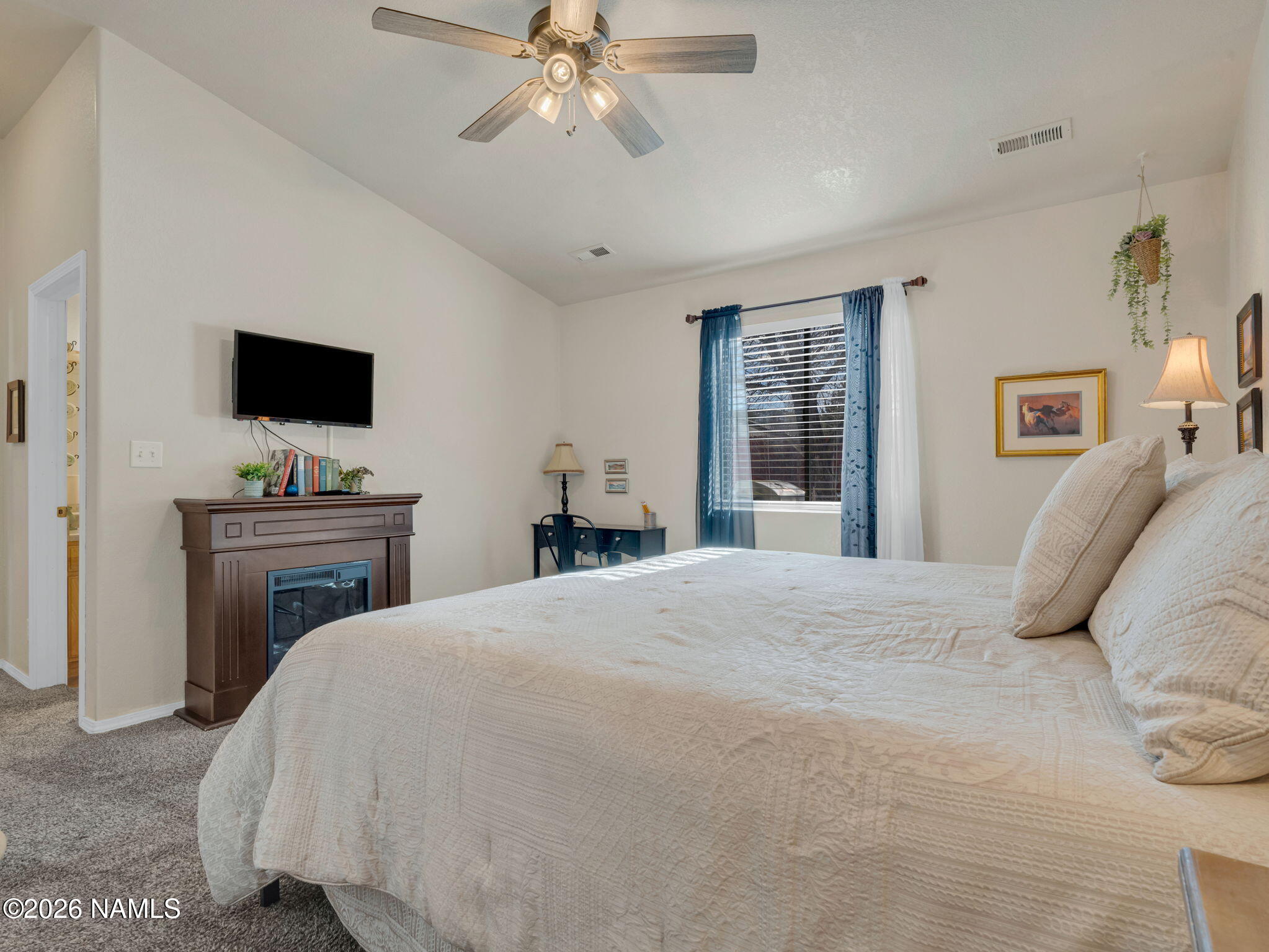 1105 West Morse Avenue Williams, AZ 86046 - Photo 14 of 26 a bedroom with a bed and a flat screen tv