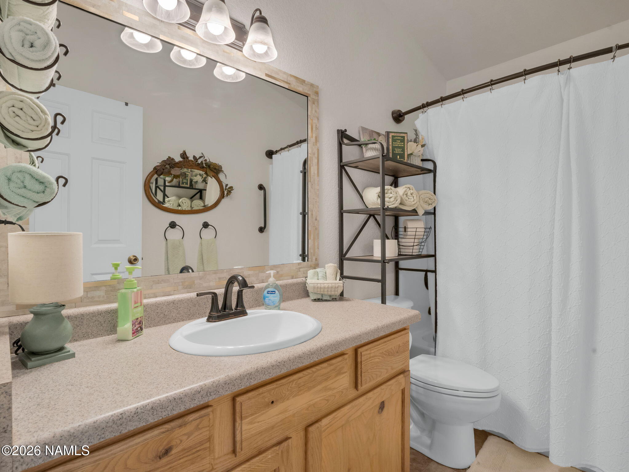 1105 West Morse Avenue Williams, AZ 86046 - Photo 15 of 26 a bathroom with a sink a toilet and a mirror