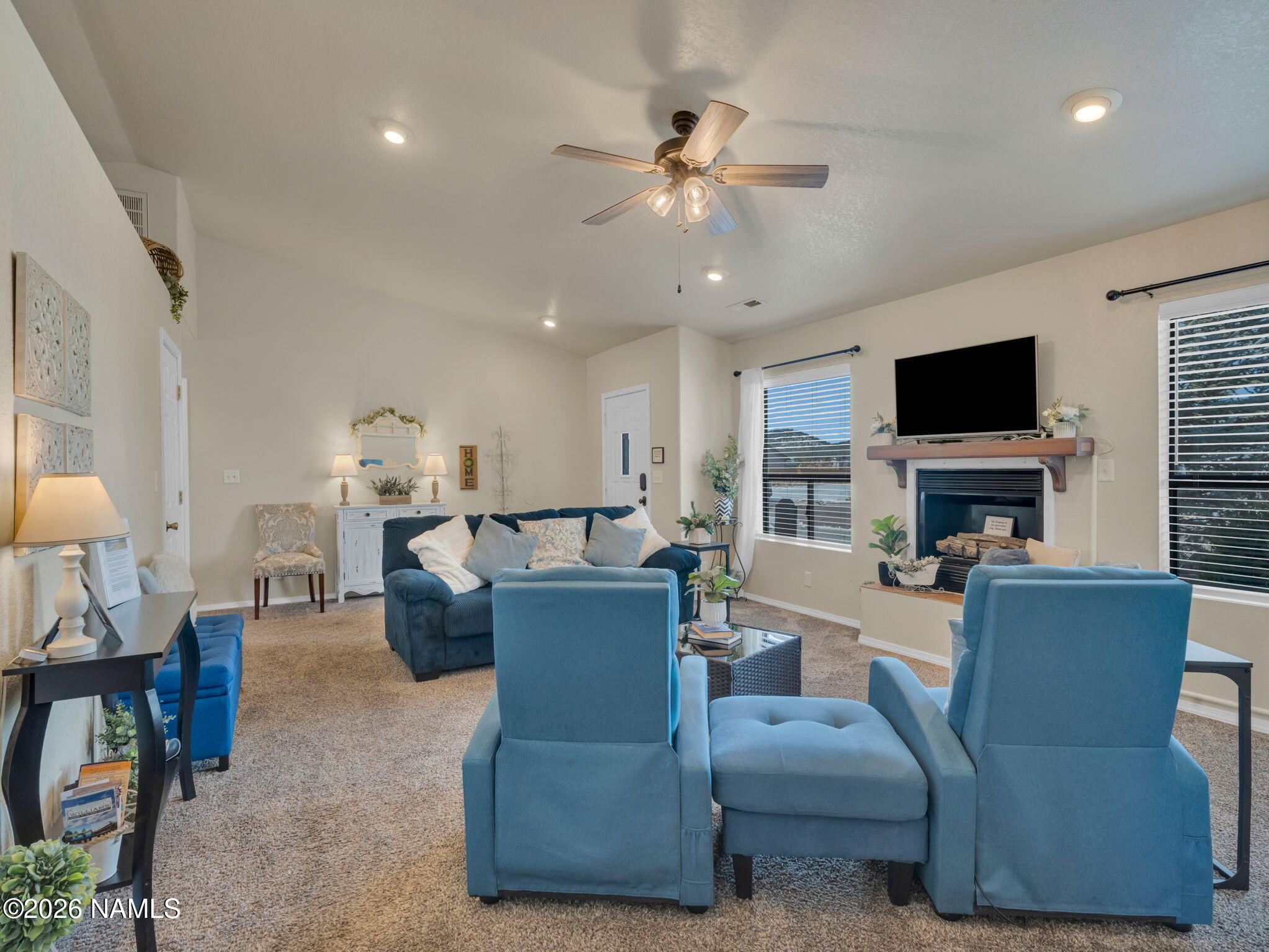 1105 West Morse Avenue Williams, AZ 86046 - Photo 6 of 26 a living room with furniture a fireplace and a flat screen tv