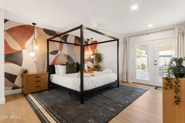 a bedroom with a bed and wooden floor