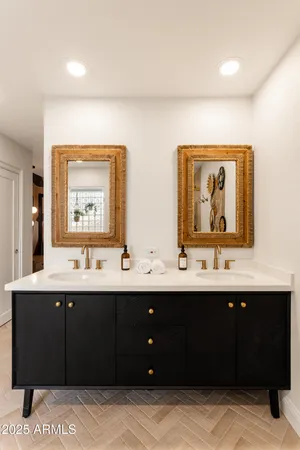 a bathroom with a double vanity sink and mirror